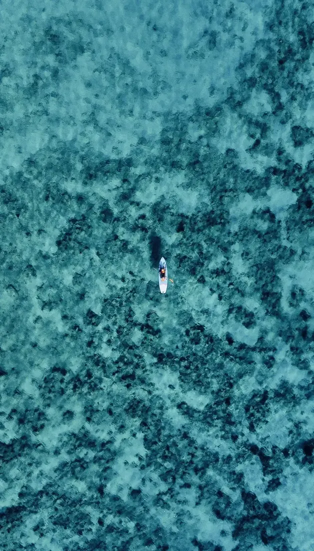 A lone kayak floating above clear turquoise water in Curaçao