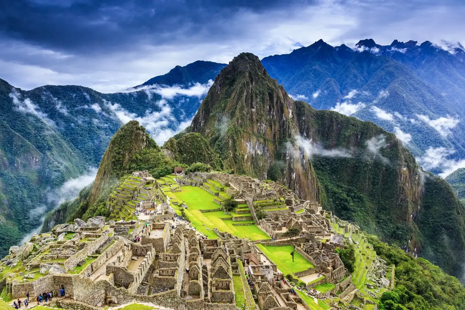 Machu Picchu’s stone terraces surrounded by green Andean peaks